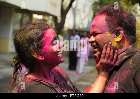 Young India couple enjoying Holi and applying dry color, Pune, India Stock Photo