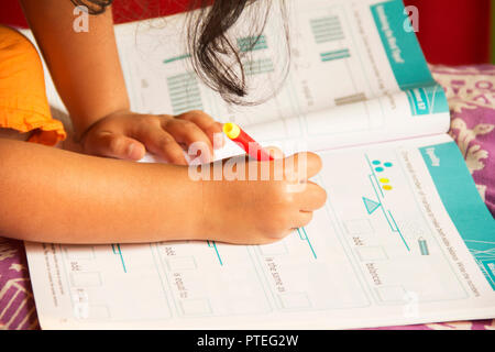 Close up little girl doing her studies, Pune, India