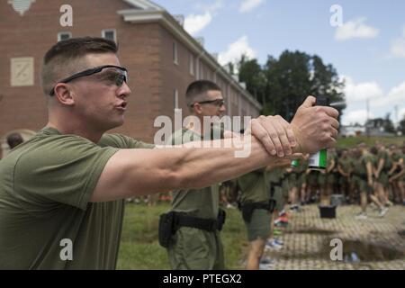 A student attached to Marine Corps Embassy Security Group goes through a oleoresin capsicum (OC) spray training course on Marine Corps Base Quantico, Va., July 7, 2017. Students are sprayed with OC as a part of their training to become Marine Security Guards. Stock Photo