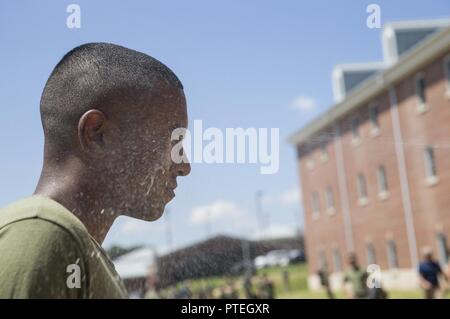 A student attached to Marine Corps Embassy Security Group is sprayed with oleoresin capsicum (OC) spray during OC training on Marine Corps Base Quantico, Va., July 7, 2017. Students are sprayed with OC as a part of their training to become Marine Security Guards. Stock Photo