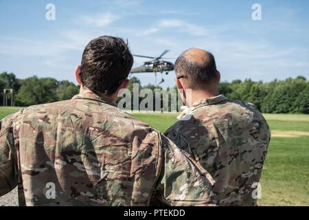 House Speaker Paul Ryan (R-Wisconsin) and Division Commander Major General Andrew Poppas watch as instructors from The Sabalauski Air Assault School demonstrate how to correctly fast rope at Fort Campbell, Kentucky, on July 10. After the demonstration the Speaker and Poppas fast roped off of the tower. Stock Photo