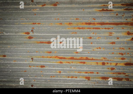 Background texture of the wall of old zinc sheet, metal sheet with rusty texture, rusty metal sheet, rusty zinc texture. Stock Photo
