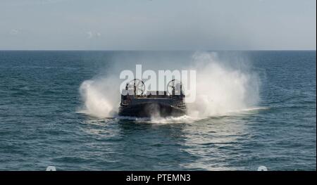 ATLANTIC OCEAN (July 14, 2017) A landing craft air cushion, assigned to Assault Craft Unit 4, approaches the amphibious assault ship USS Iwo Jima (LHD 7) during well deck operations. Iwo Jima is underway with Amphibious Squadron (PHIBRON) FOUR and the 26th Marine Expeditionary Unit (MEU) conducting PHIBRON-MEU Integrated Training in preparation for their upcoming deployment. Stock Photo