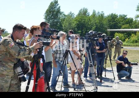 PAPA AIR BASE, Hungary — Local media appear for a conference with notable guests Gen. Tibor Benko, Chief of Defence of Hungary; David Kostelancik, charge d'affaires of the U.S. Embassy in Budapest, Hungary; Gen. Ben Hodges, commander, U.S. Army Europe. The three visited Papa Air Base for the loading of 449 paratroopers from various countries into multiple C-130 Hercules aircraft. The paratroopers departed Papa to conduct airborne operations. Stock Photo