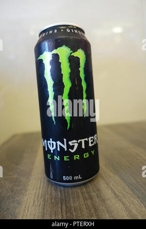 Monster Energy Drink on wooden table Stock Photo