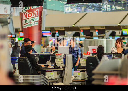 Passengers queue at the passport control counter at the