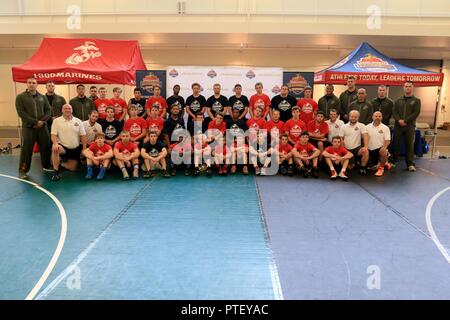 U.S. Marines with Recruiting Station Baltimore, Marine Corps Recruiting Command, coaches, and young wrestlers pose during the United States Marine Corps Sports Leadership Academy at York College in York, Pa., July 18, 2017. The academy combines athlete development with character building with Marines and coaches. Stock Photo