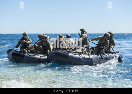 CORAL SEA (July 20, 2017) Soldiers assigned to 2nd Battalion, Royal Australian Regiment, depart the well deck of the amphibious transport dock USS Green Bay (LPD 20) in combat rubber raiding crafts during Talisman Saber 17. Talisman Saber is a biennial U.S.-Australia bilateral exercise held off the coast of Australia meant to achieve interoperability and strengthen the U.S.-Australia alliance. Stock Photo