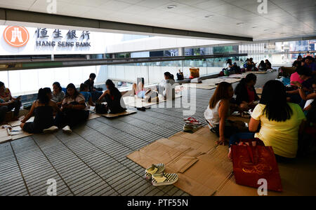 Filipino domestic helpers enjoying their Sunday ( day off ) in Hong Kong Central district. Stock Photo