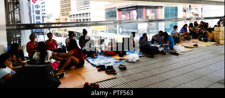 Filipino domestic helpers enjoying their Sunday ( day off ) in Hong Kong Central district. Stock Photo