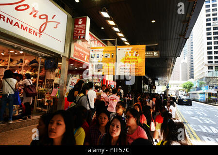 Filipino domestic helpers enjoying their Sunday ( day off ) in Hong Kong Central district. Stock Photo