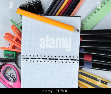 opened Notepad on office supplies on white background Stock Photo