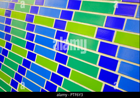 green and blue tile bricks on exterior of building Stock Photo