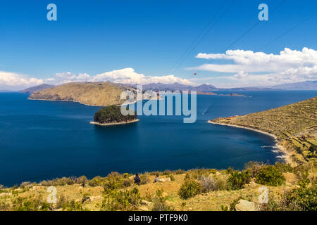 Terraced landscape of Isla del Sol with Andes mountains in the background on the Bolivian side of Lake Titicaca Stock Photo