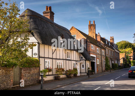 England, Berkshire, Streatley, High Street, Thatched Cottage in line of historic brick and flint faced houses Stock Photo