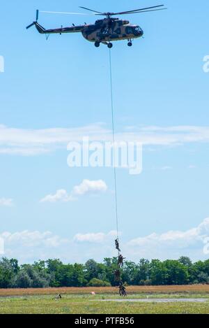 Hungarian special operations forces are lifted to a MI-8 (HIP) Multirole Medium-Lift Helicopter via a Special Patrol Insertion/Extraction system July 12 during exercise Black Swan in Szolnok, Hungary. Black Swan was a Hungarian-led special operations forces exercise from June 26 – July 22, 2017 across locations in Bulgaria, Hungary and Romania and included participants from over eight countries. Paratroopers from the U.S. Army’s 173rd Airborne Brigade and 10th Combat Aviation Brigade also participated in the exercise alongside the 20th Special Forces Group (Airborne) to improve integration bet Stock Photo