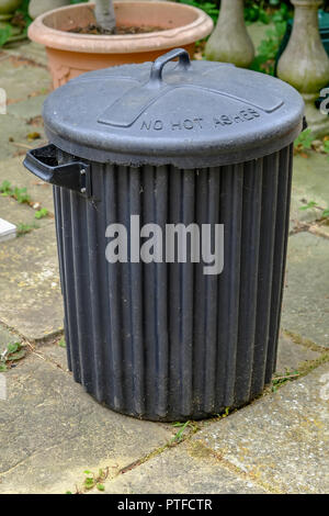 Old black bin made of fibreglass.  Looks grundgy and has the lid in place.  No Hot Ashes is written on the top. Stock Photo