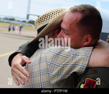 Maj. Richard, 432nd Wing MQ-1 Predator pilot, hugs his uncle July 15, 2017, at the Lethbridge International Airshow in Alberta, Canada. Richard had the opportunity to visit family and friends while displaying the MQ-9 Reaper at the airshow where he first fell in love with aviation.