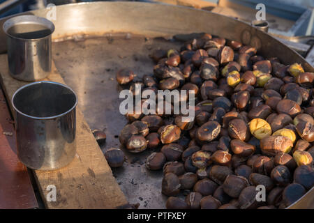 Roast chestnuts cooked over the red-hot grill,'Caldarroste', roasted chestnuts on sale in many Italian streets between Autumn and Winter Stock Photo