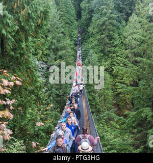 VANCOUVER, CANADA - SEPTEMBER 11th 2018: Visitors cross the 450 ft Capilano suspension bridge in North Vancouver Stock Photo