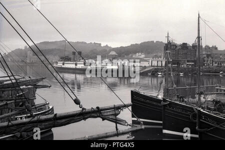 1950s, historical, large passenger steamship moored in Oban harbour, Scotland, UK. The bay at Oban in the Firth of Lorn became the gateway to the Western highlands and Islands of Scotland for visitors travelling by ship. Stock Photo