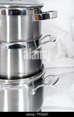 Metal pans on a light shiny background Stock Photo