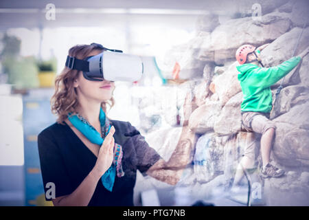 Composite image of female executive wearing virtual reality headset Stock Photo