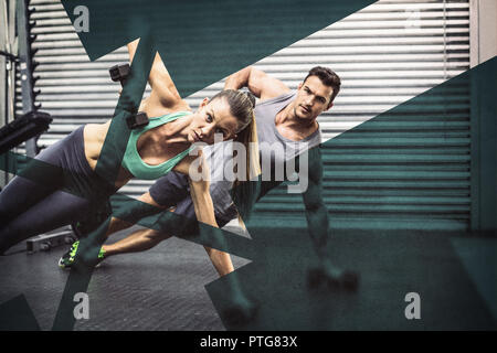 Smiling muscular couple doing side plank Stock Photo