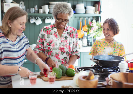 Senior women friends cooking in kitchen Stock Photo
