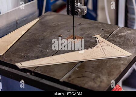 Eco-friendly woodworker's shop. Details and focus on the texture of the material, sawdust, and planers or chisels, while making legs for a nut desk. Stock Photo