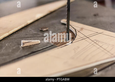 Eco-friendly woodworker's shop. Details and focus on the texture of the material, sawdust, and planers or chisels, while making legs for a nut desk. Stock Photo