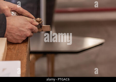 Eco-friendly woodworker's shop. Details and focus on the texture of the material, sawdust, and planers or chisels, while making legs for a nut desk. Stock Photo