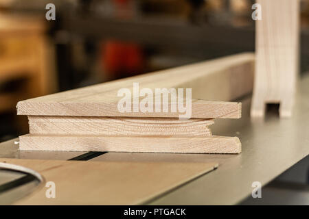 Eco-friendly woodworker's shop. Details and focus on the texture of the material, sawdust, and planers or chisels, while making legs for a nut desk. Stock Photo