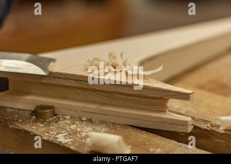Eco-friendly woodworker's shop. Details and focus on the texture of the material, sawdust, and planers or chisels, while making legs for a nut desk. Stock Photo