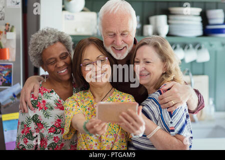 Active senior friends taking selfie with camera phone Stock Photo