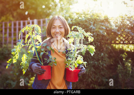 Portrait smiling, confident active senior woman gardening Stock Photo