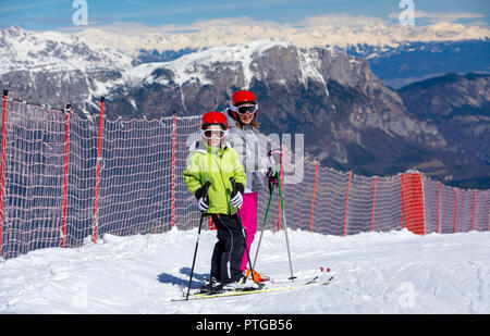 Happy children ready for skiing in the high mountains Stock Photo