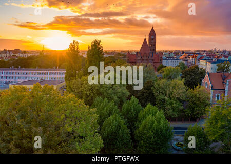 The Roman Catholic Co-Cathedral St. Stanisław Biskupa Martyr in Ostrow Wielkopolski, Poland. Aerial view to church and old town during sunset. Stock Photo
