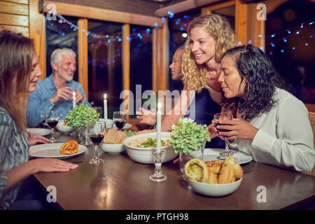Friends enjoying dinner in cabin Stock Photo