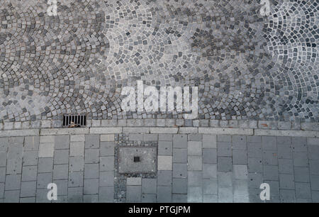 Cobblestones and sidewalk seen from above. Stock Photo