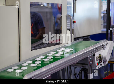 Product of plastic gears from electric injection molding machine Stock Photo