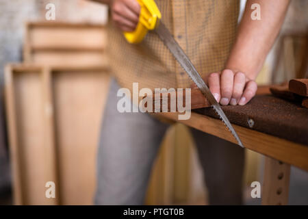 Close-up view of a joiner sawing wood Stock Photo
