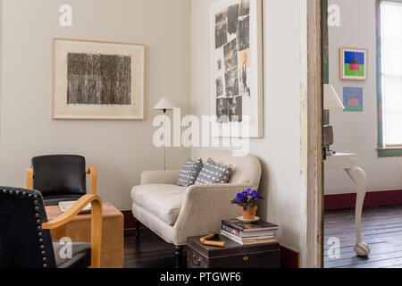Salvaged linen sofa with 1950’s black leather Bentwood chairs. Artwork by James Turrell. Stock Photo
