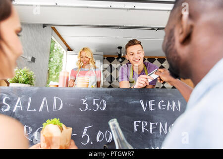 customers giving credit card at food truck seller Stock Photo