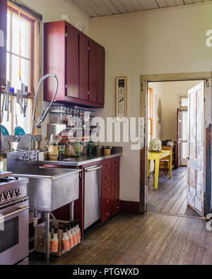 Storage in small kitchen painted traditional barn red Stock Photo