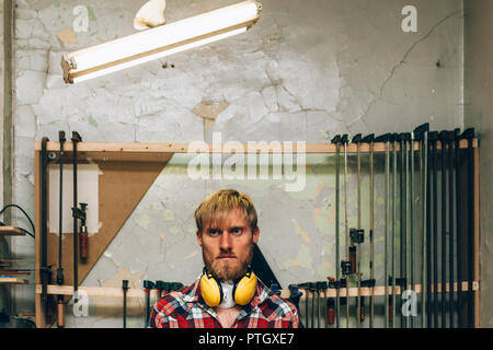 face portrait of a workman in his workshop Stock Photo