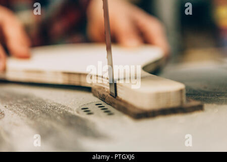 close up of the hands of a worker while sawing wood Stock Photo