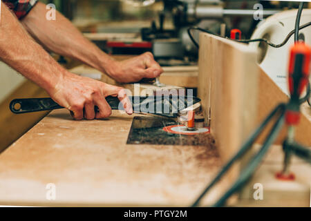 close up of the hands of a carpenter using a lathe Stock Photo