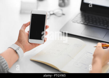 web designer working on smartphone user interface Stock Photo