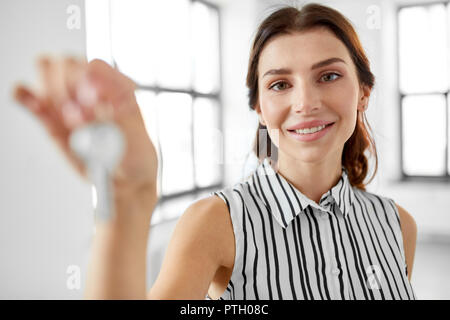 woman realtor with key at office Stock Photo